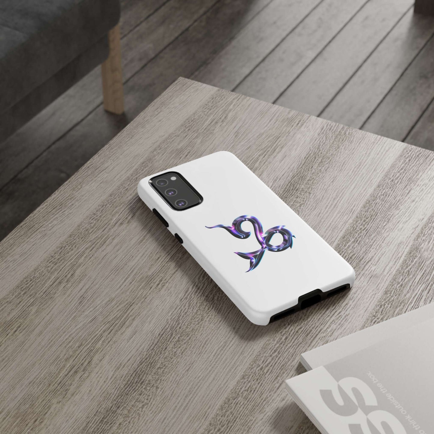 Personalized Zodiac phone case with vibrant Capricorn design on a wooden table, showcasing stylish cosmic flair.