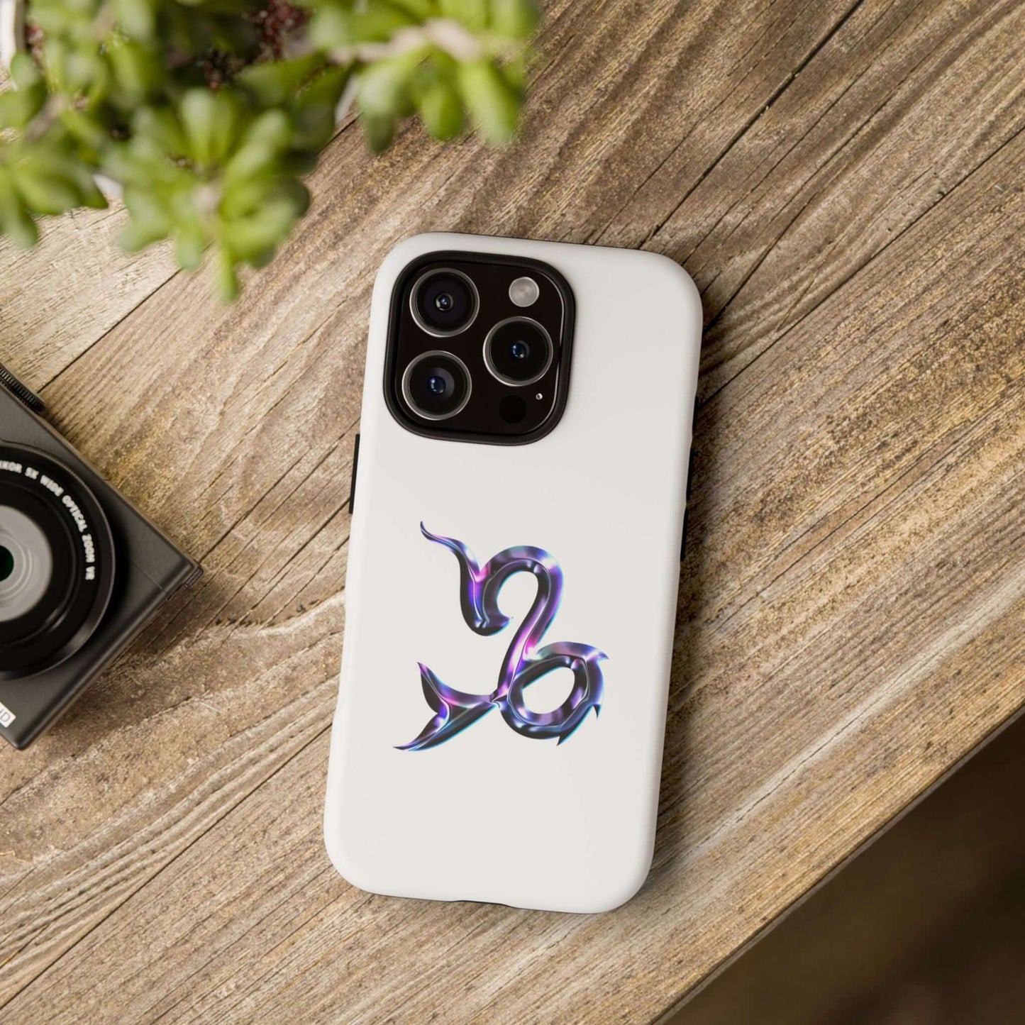 Personalized Zodiac phone case with Capricorn design on a wooden surface, perfect for astrology lovers.
