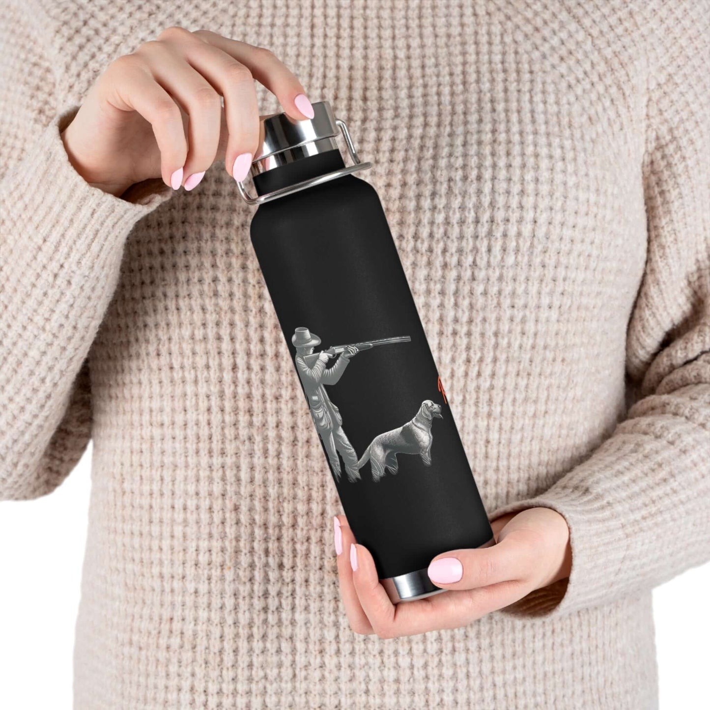 Person holding a personalized copper vacuum insulated bottle with a hunter and dog graphic.
