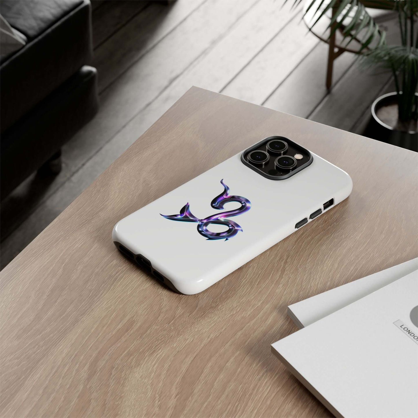 Stylish personalized Zodiac phone case on a wooden table, showcasing a vibrant sign design for astrology lovers.