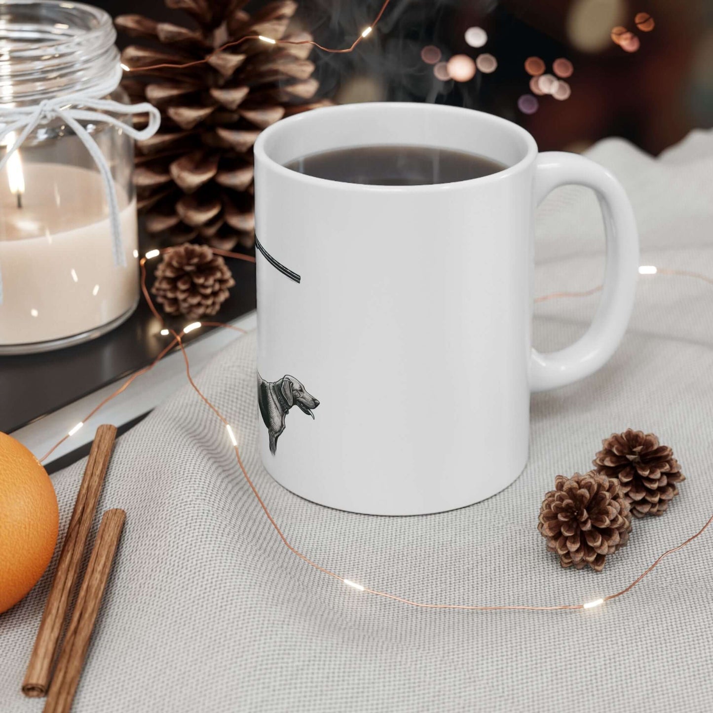 Personalized white hunting mug with coffee, set against cozy autumn decor including pinecones and a candle.