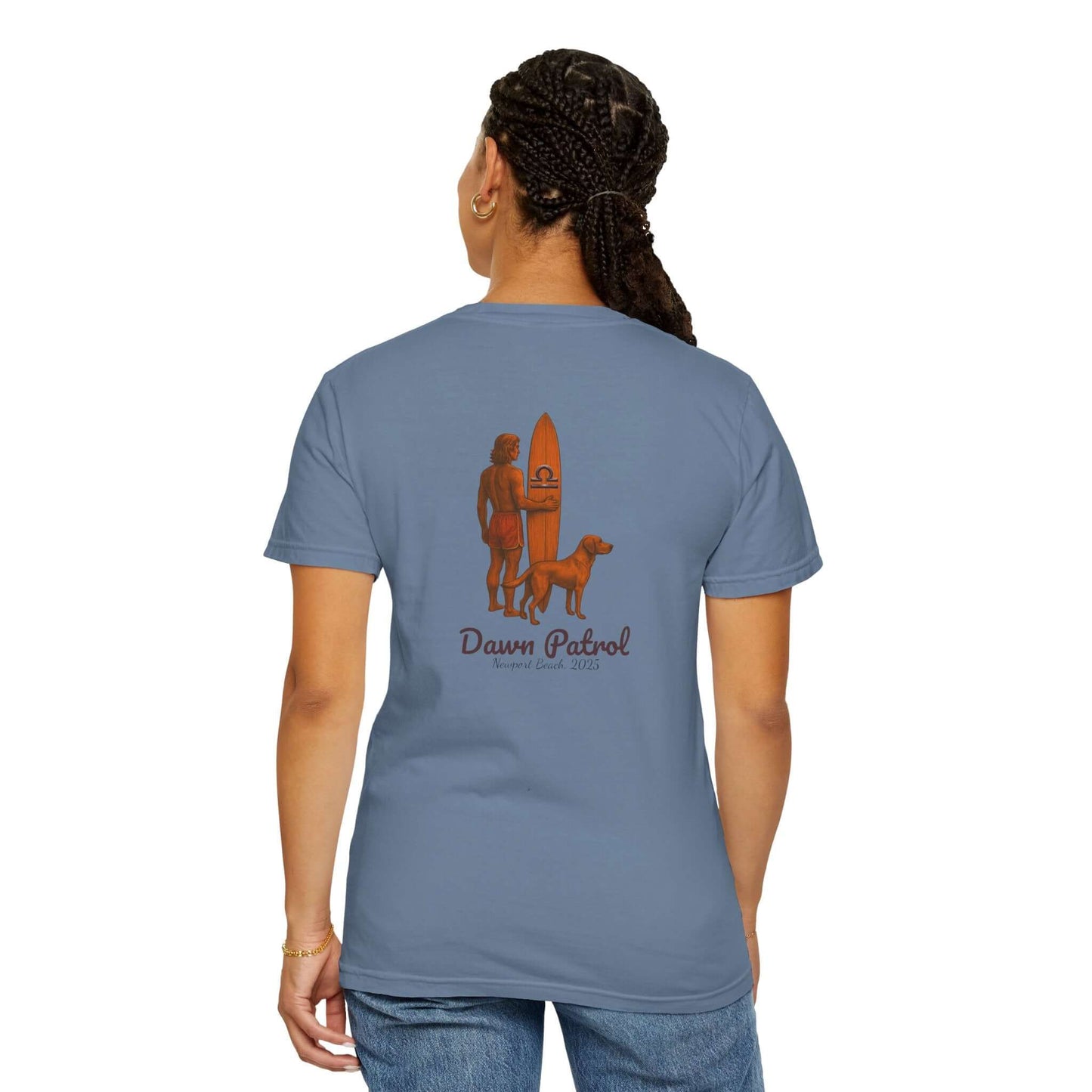Back view of a blue t-shirt featuring a surfer and dog design, captioned 'Dawn Patrol', perfect for beach lovers.