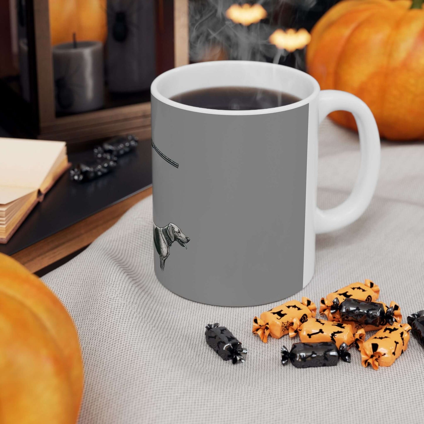 Personalized gray hunting mug with coffee surrounded by autumn decorations and treats.