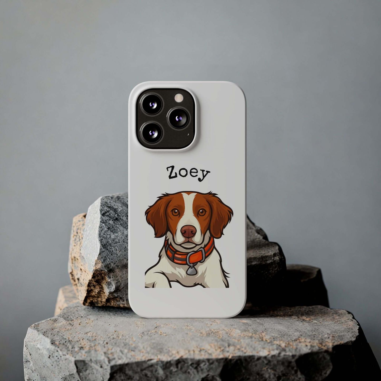 Custom dog phone case featuring cartoon illustration of a dog named Zoey on a stylish white background.