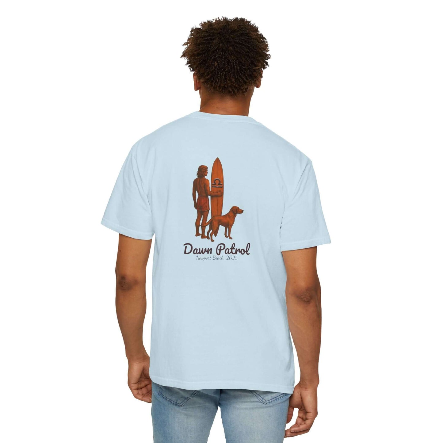 Back view of a light blue t-shirt featuring a surfer, dog, and 'Dawn Patrol' graphic, perfect for beach lovers.