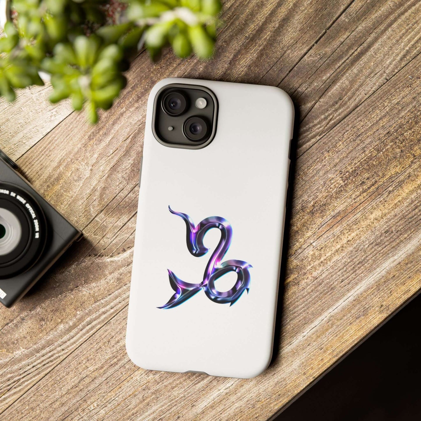 Personalized zodiac phone case with a colorful design showcasing a star sign symbol on a wooden table.
