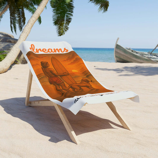 Beach chair with surf art and 'Dreams' text on sandy beach, palm trees, and ocean backdrop.