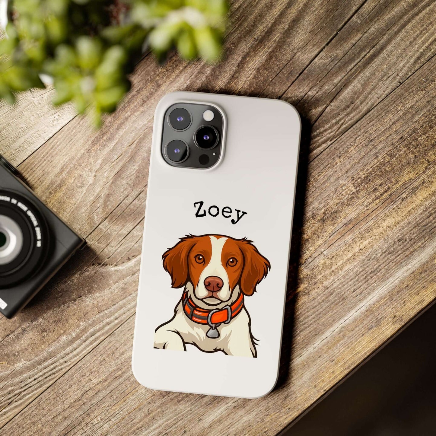 Custom cartoon phone case featuring a dog named Zoey on a wooden table with a camera.