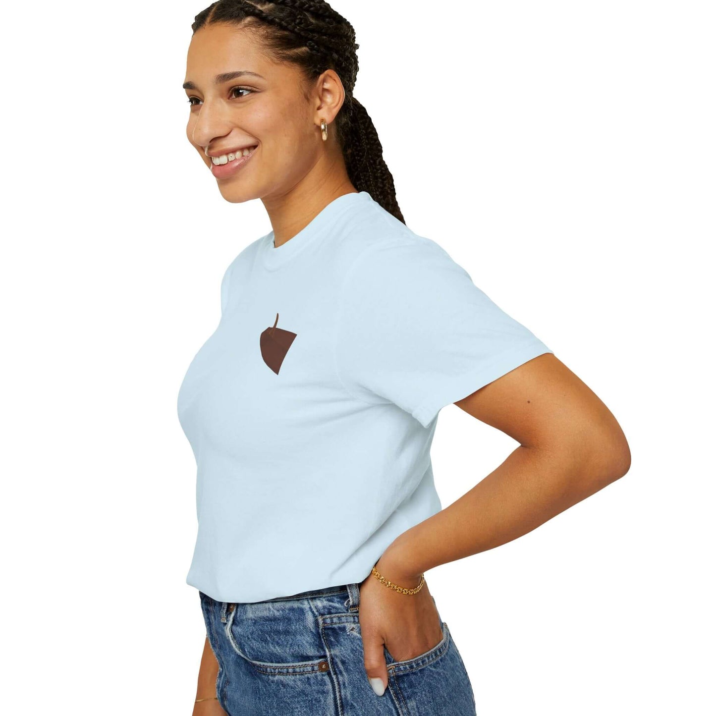 Smiling woman in a blue personalized t-shirt with a simple acorn design, showcasing casual beach-inspired style.