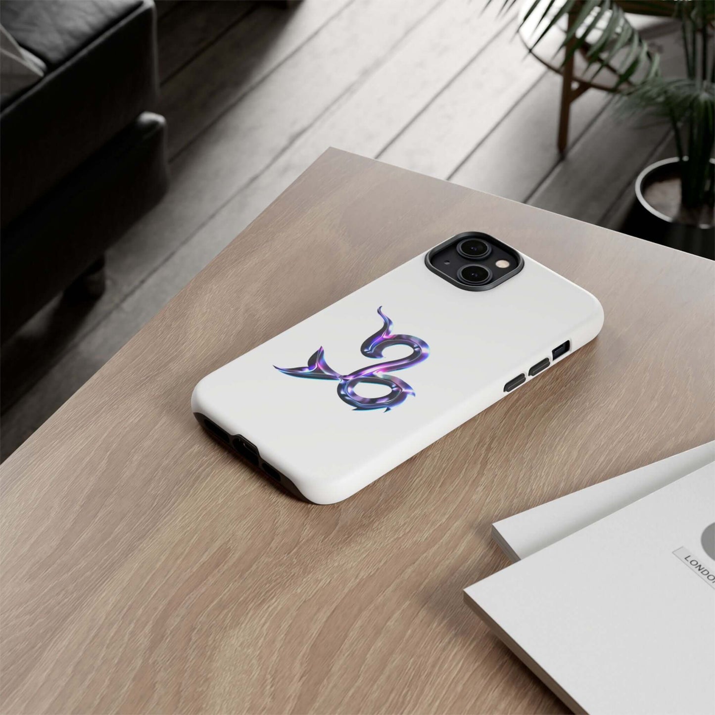 Stylish personalized Zodiac phone case featuring a vibrant multi-color design on a wooden table.