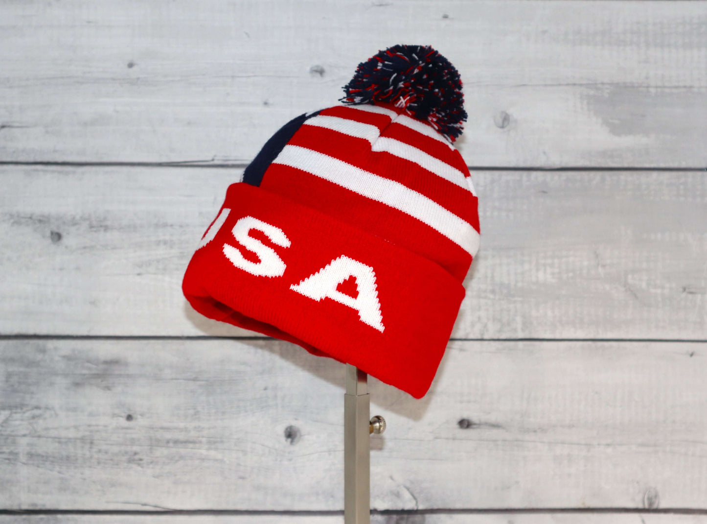 Child Specialty Hat (Ages 3–5) – Playful Warmth with Purpose in red and white with a pom-pom on top.