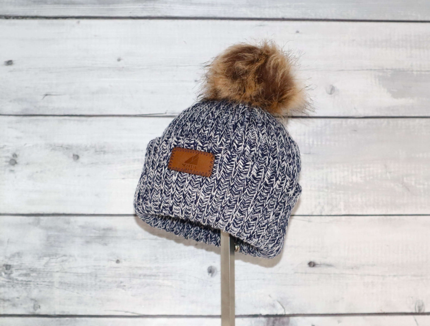 Toddler Acrylic Ribbed Cuff with Pom Hat – Cozy & Purposeful displayed on a wooden background.