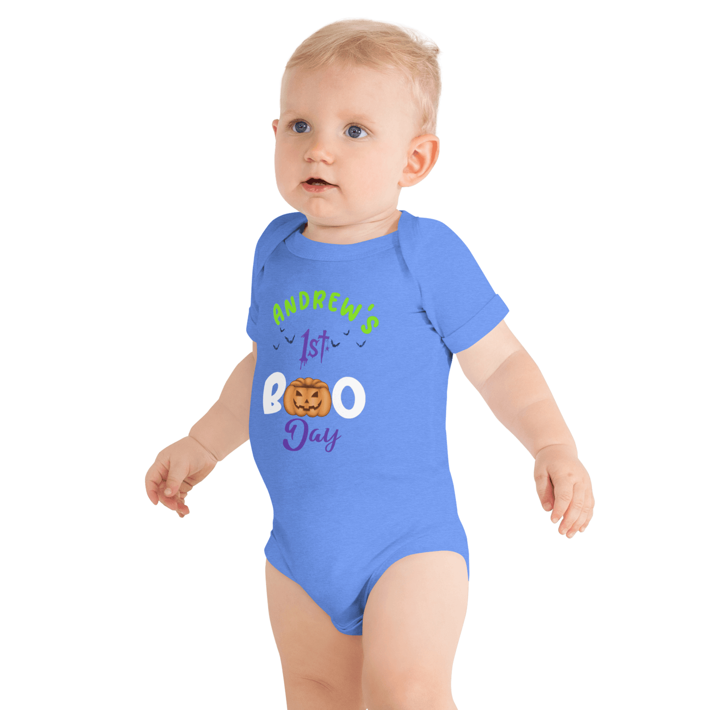 Baby wearing personalized blue bodysuit with pumpkin design celebrating 1st Halloween, featuring playful spooky text.