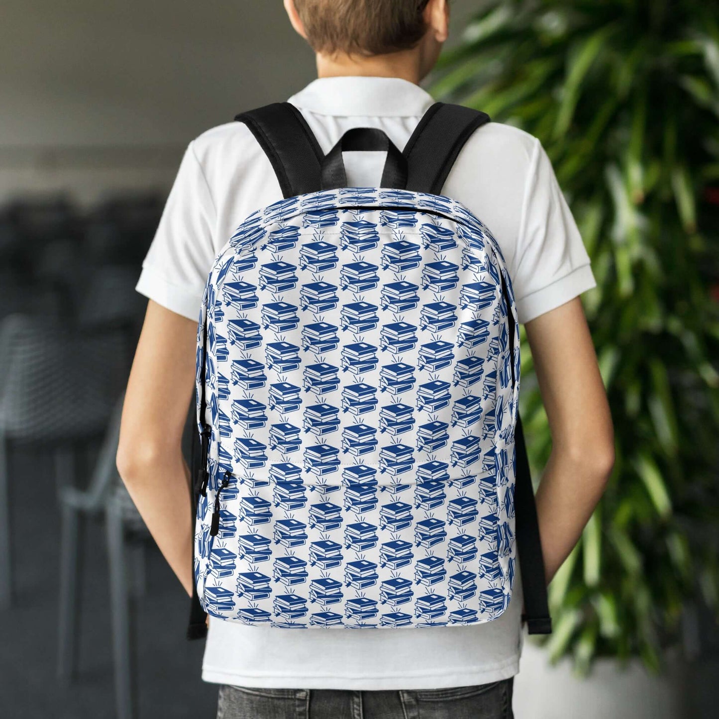 Boy wearing The Bookish Backpack with a geometric book pattern, perfect for students and creatives.