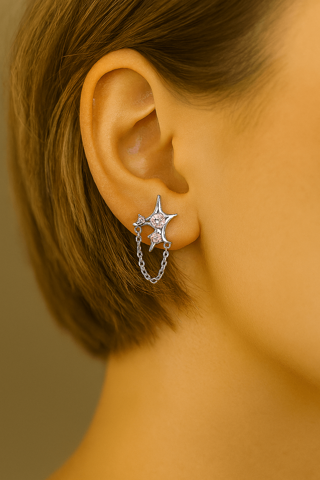 Celestial Chain Drop Earrings with Pink Zirconia and Star Charms worn by a model, showcasing their elegant design.