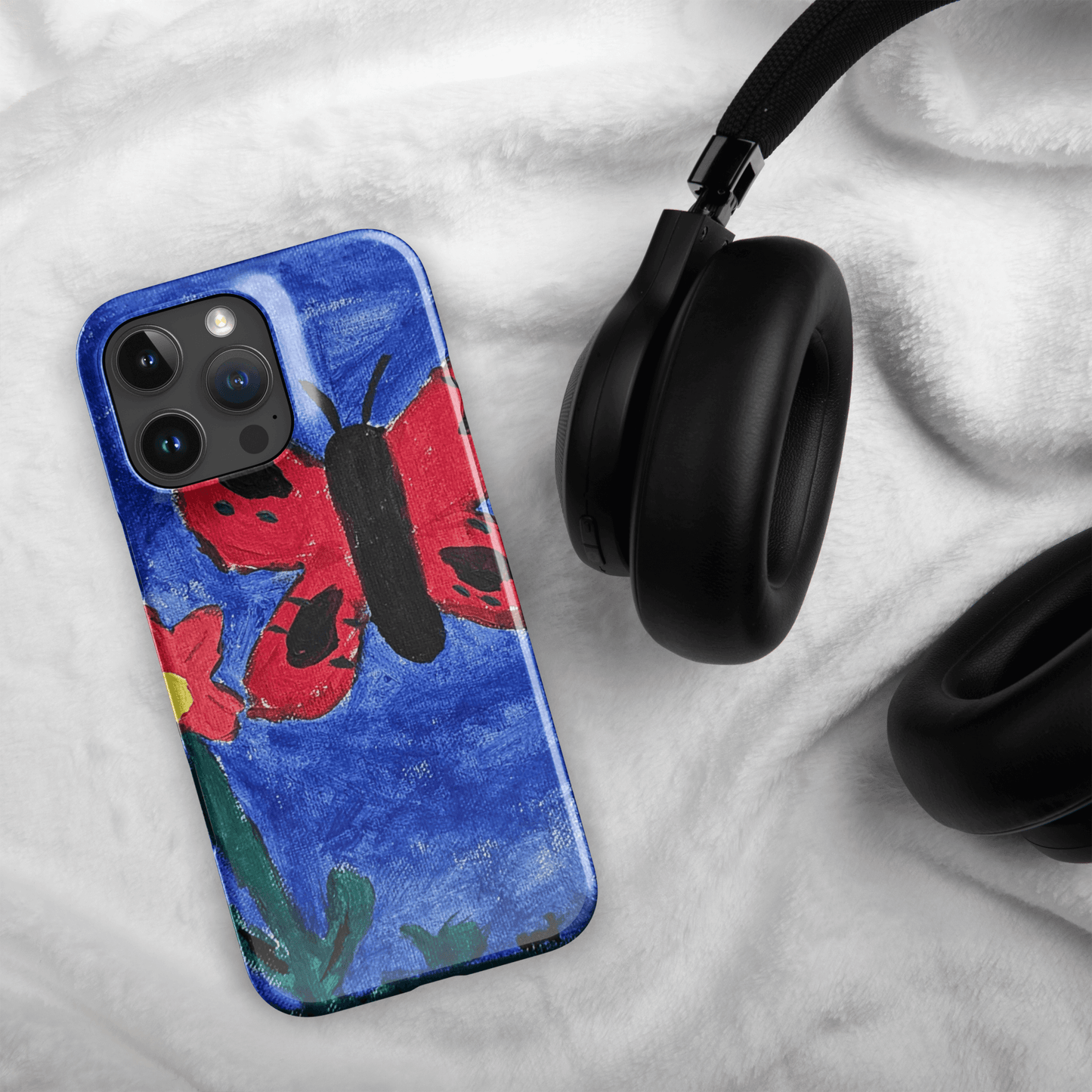 Custom iPhone case featuring a colorful butterfly painting alongside headphones, blending art and style.