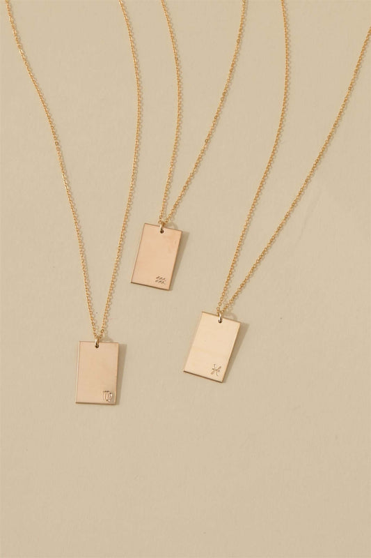 Goldie Horoscope Necklace – Hand-Stamped Zodiac in Gold-Filled displayed with multiple gold-filled pendants on a neutral background.