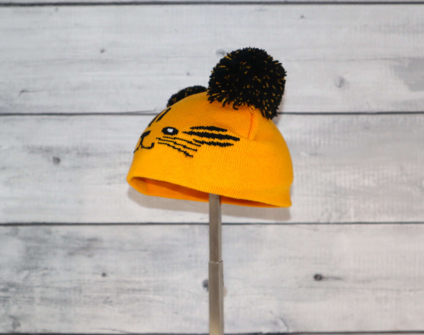 Infant Specialty Hat – Cozy, Playful, Purposeful in playful yellow with pom poms for infant comfort and style.