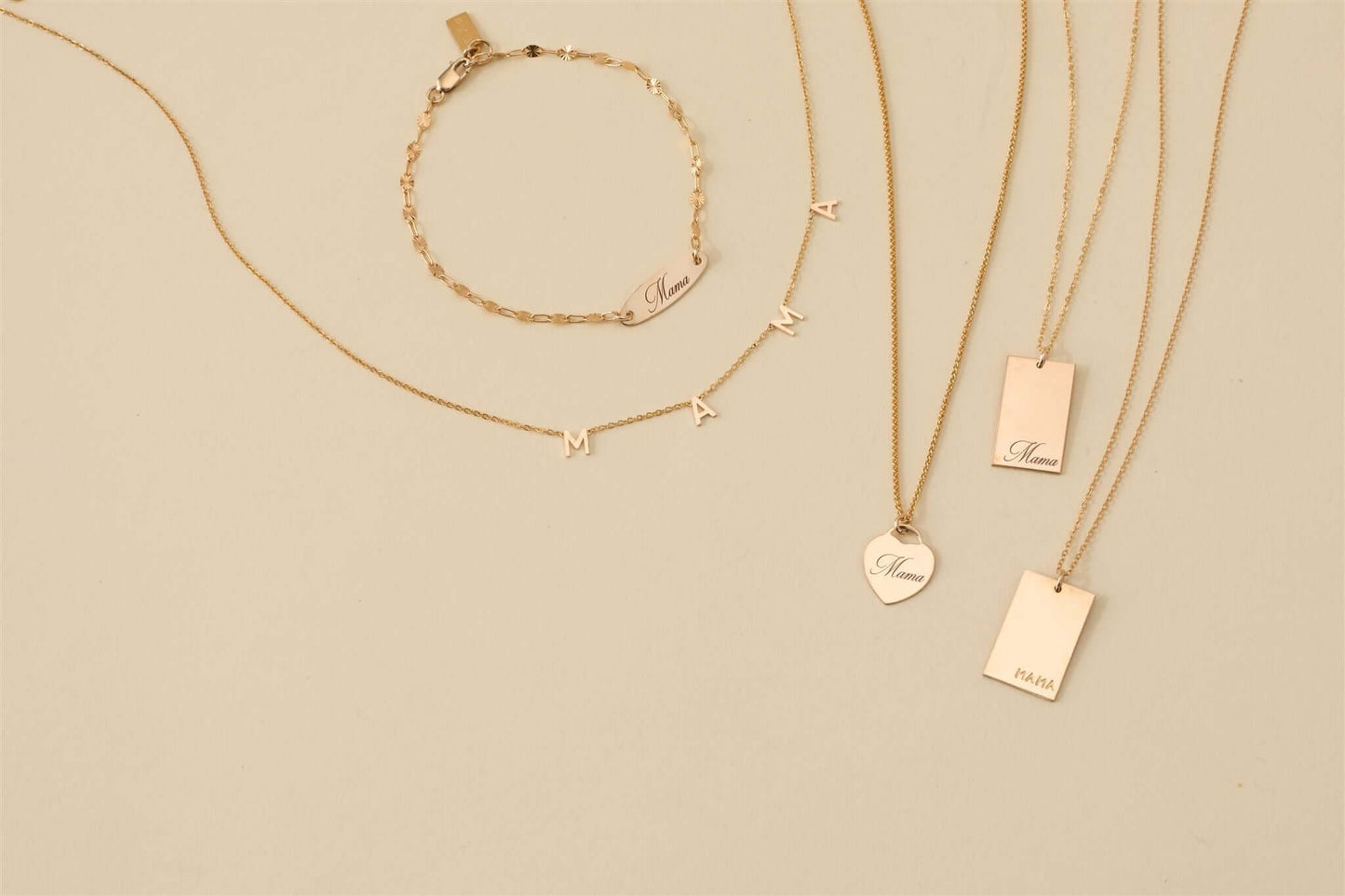 Mama Alice Necklace – 14k Gold-Filled Heart on Wheat Chain alongside additional gold jewelry pieces.