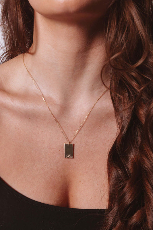 Mama Stella Necklace – 14k Gold-Filled Hand-Engraved Pendant worn on model showcasing its elegant design.
