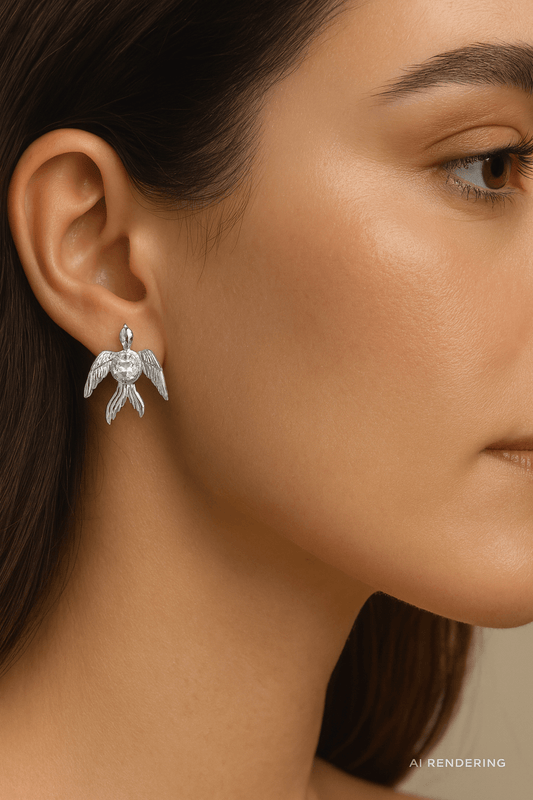 Phoenix Studs featuring radiant crystal wings worn by a model, showcasing bold transformation and elegance.