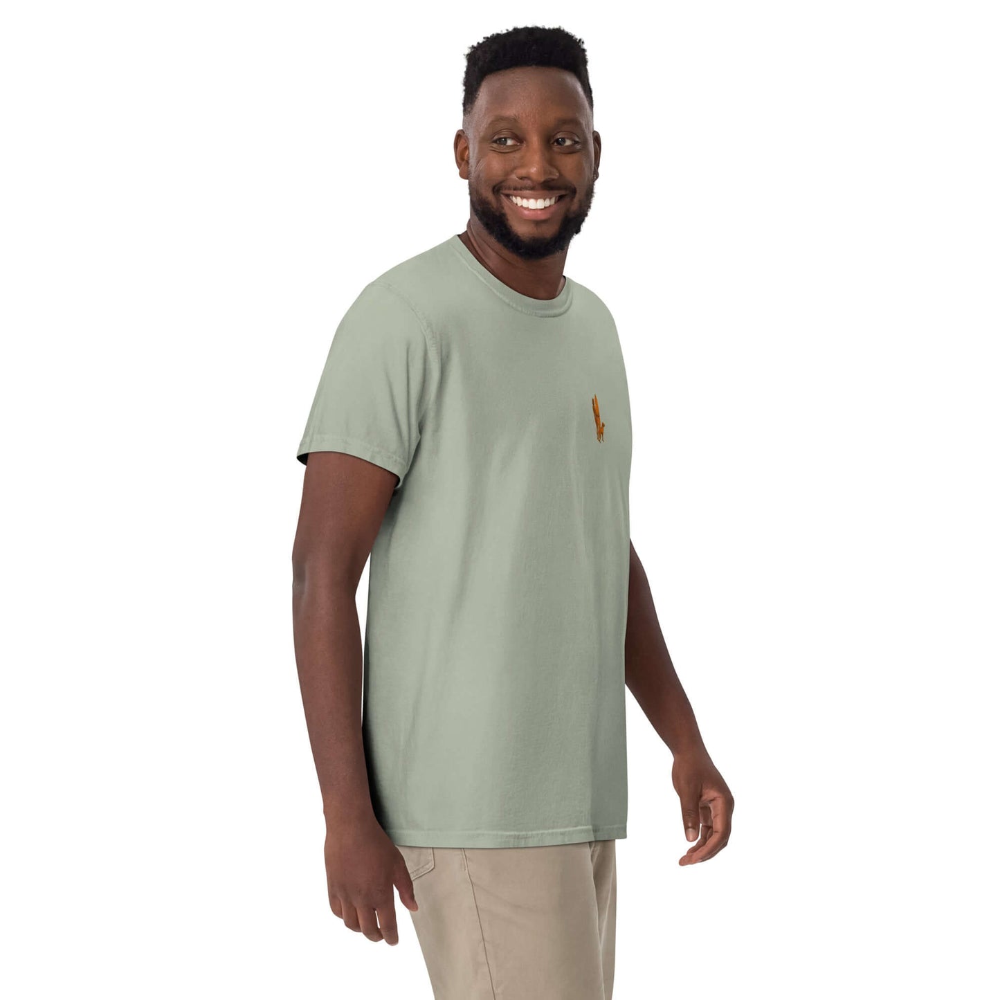 Model wearing the Surf Sunset Heavyweight Tee in green, showcasing minimalist surfer-and-dog design.