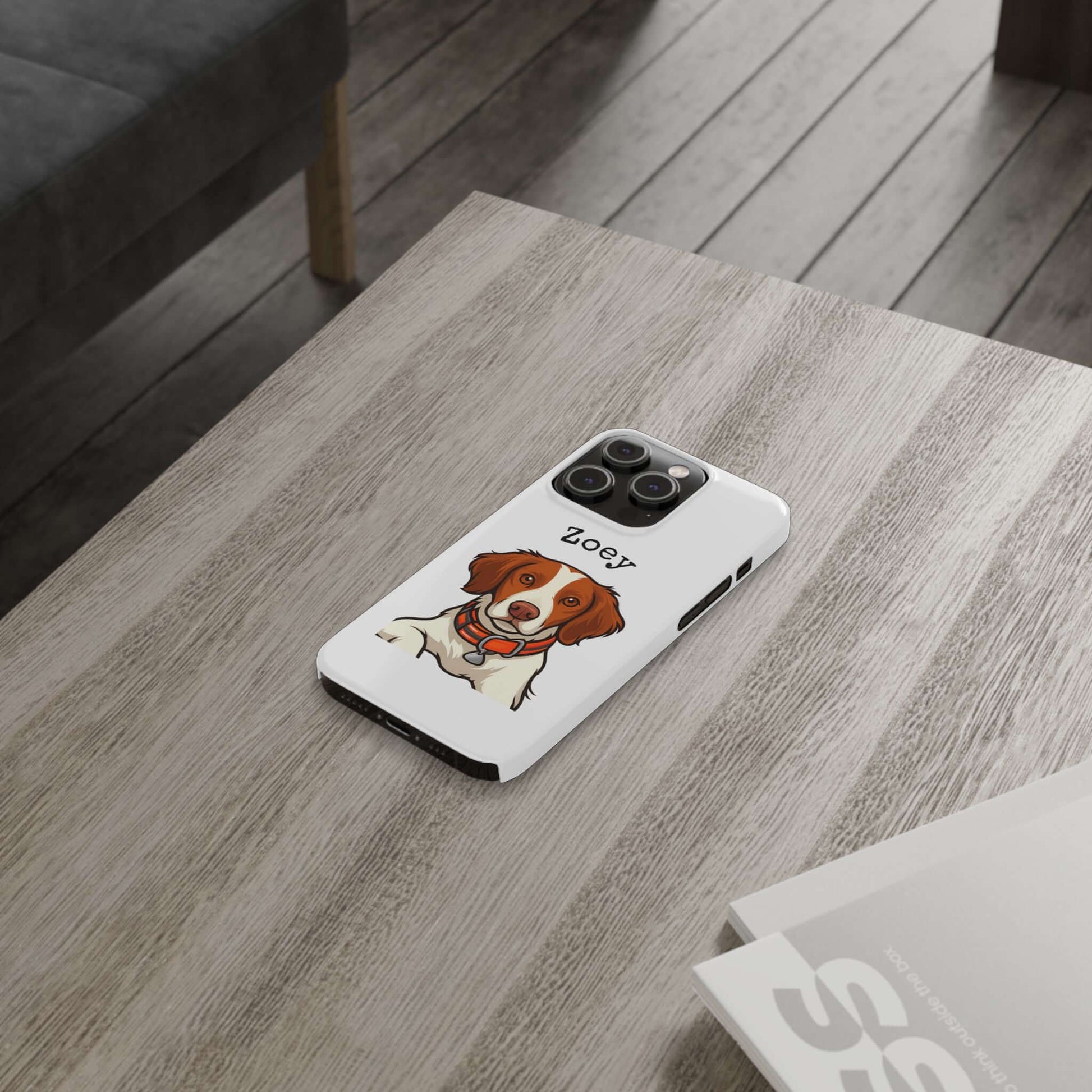 Custom dog cartoon phone case featuring a playful illustration of a dog named Zoey on a wooden table.