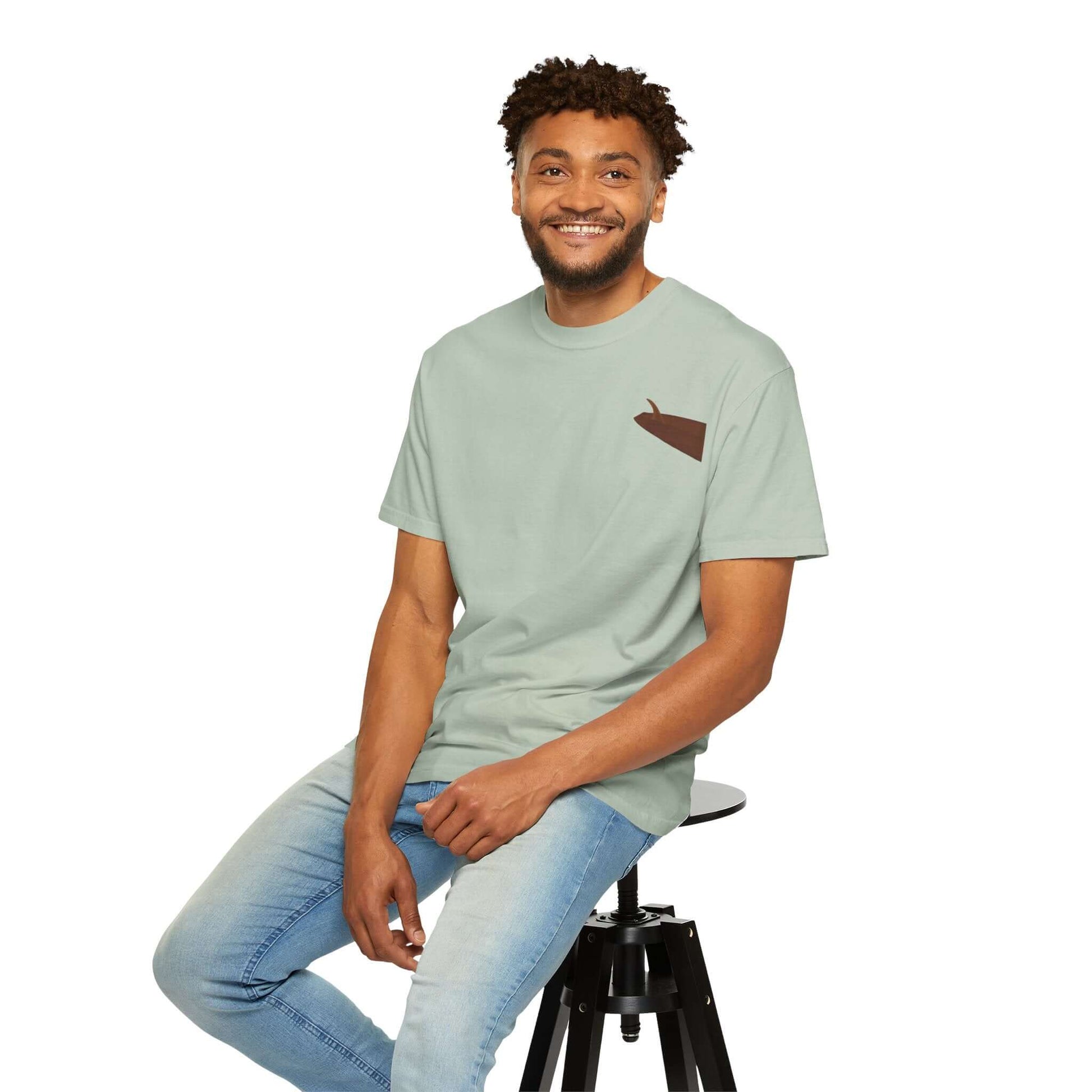 Smiling man wearing a personalized surf-inspired t-shirt in mint green, showcasing casual summer style.