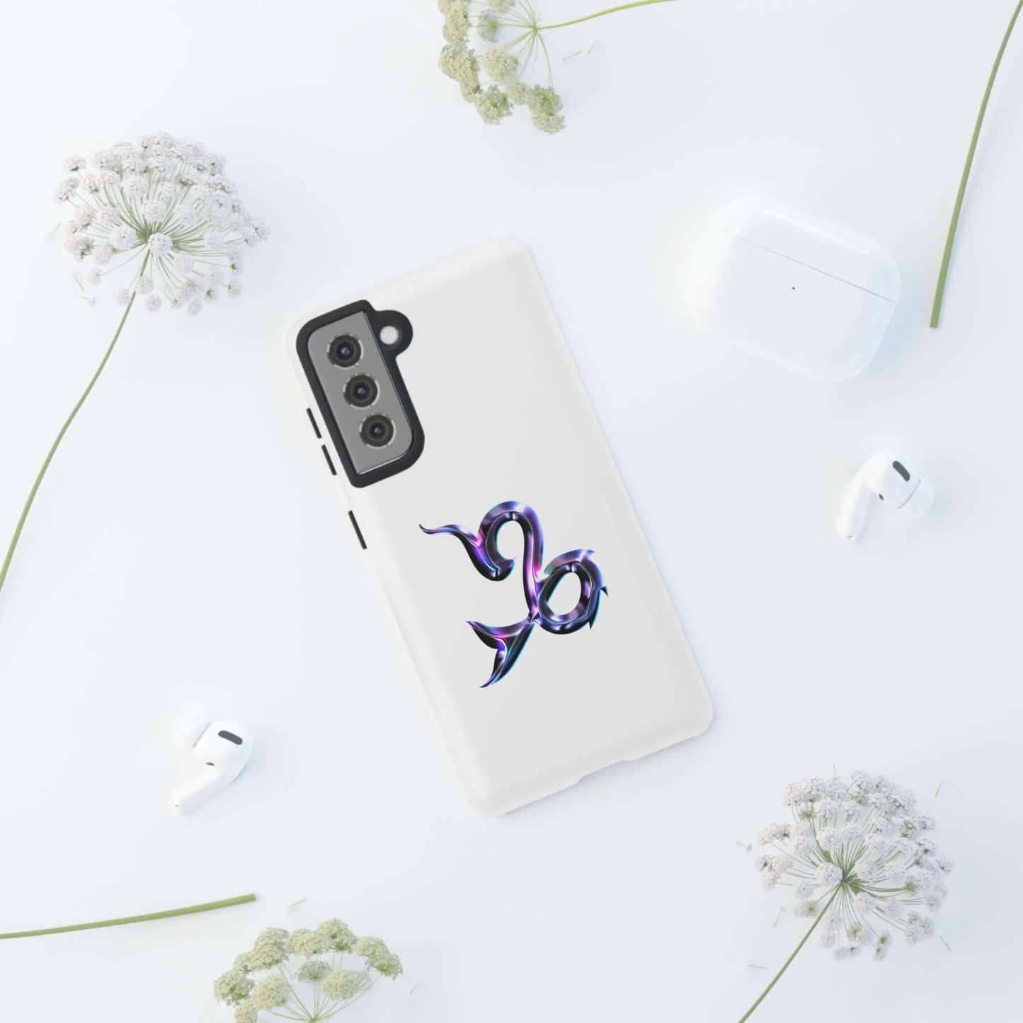 Personalized Zodiac phone case featuring a vibrant Capricorn design, surrounded by stylish accessories.