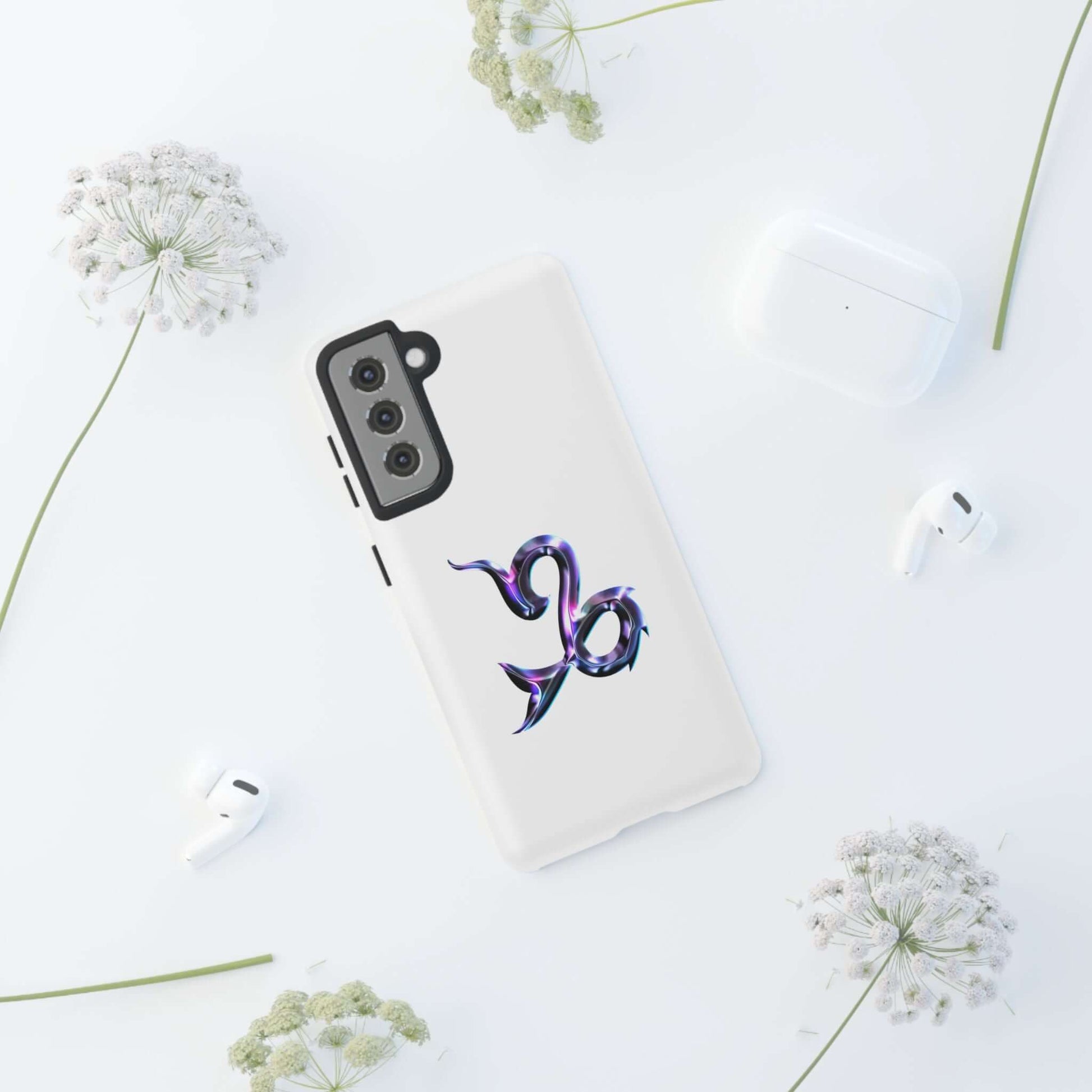 Personalized Zodiac phone case featuring a vibrant Capricorn design, surrounded by stylish accessories.