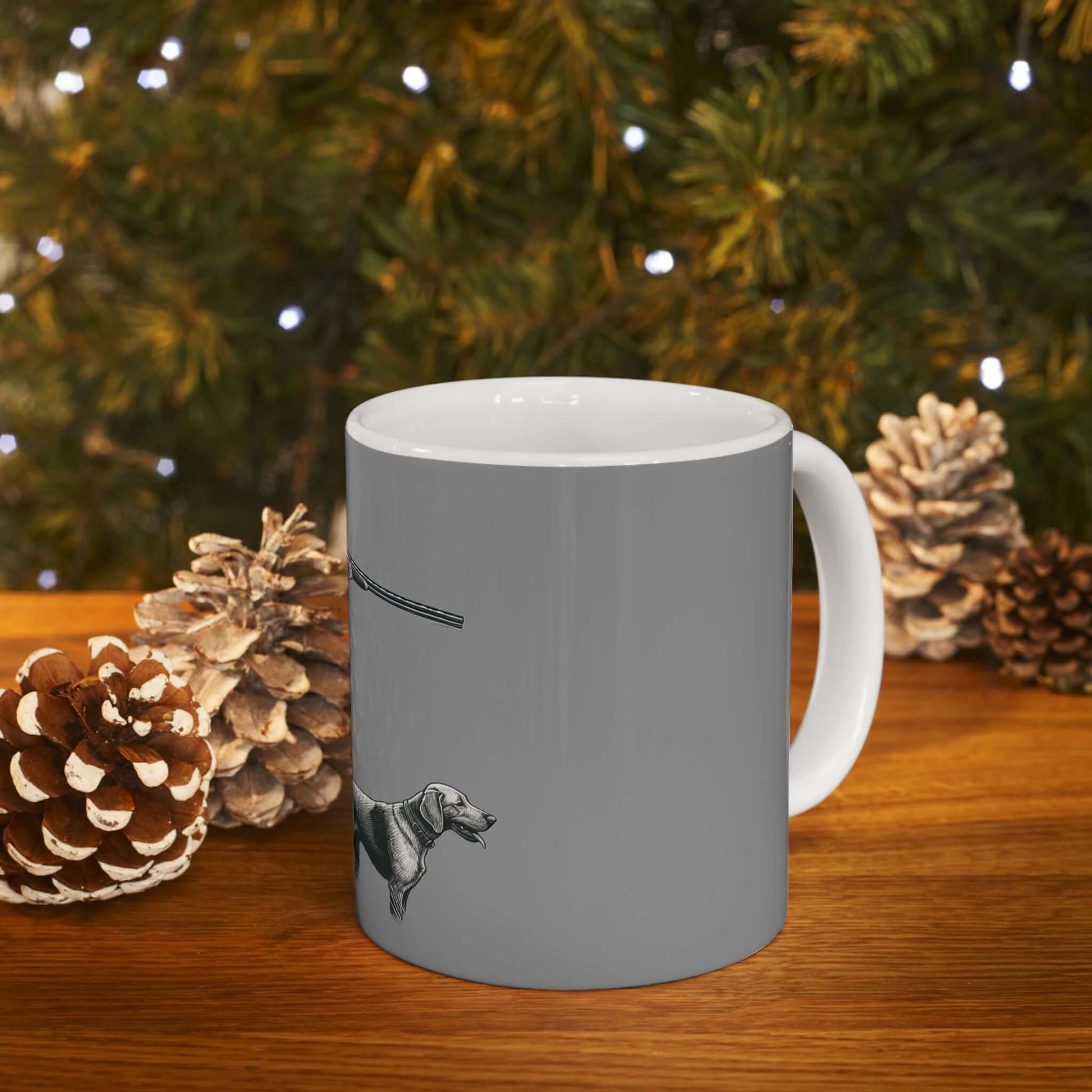 Personalized gray hunting mug featuring a dog design, surrounded by pinecones for a cozy, rustic feel.