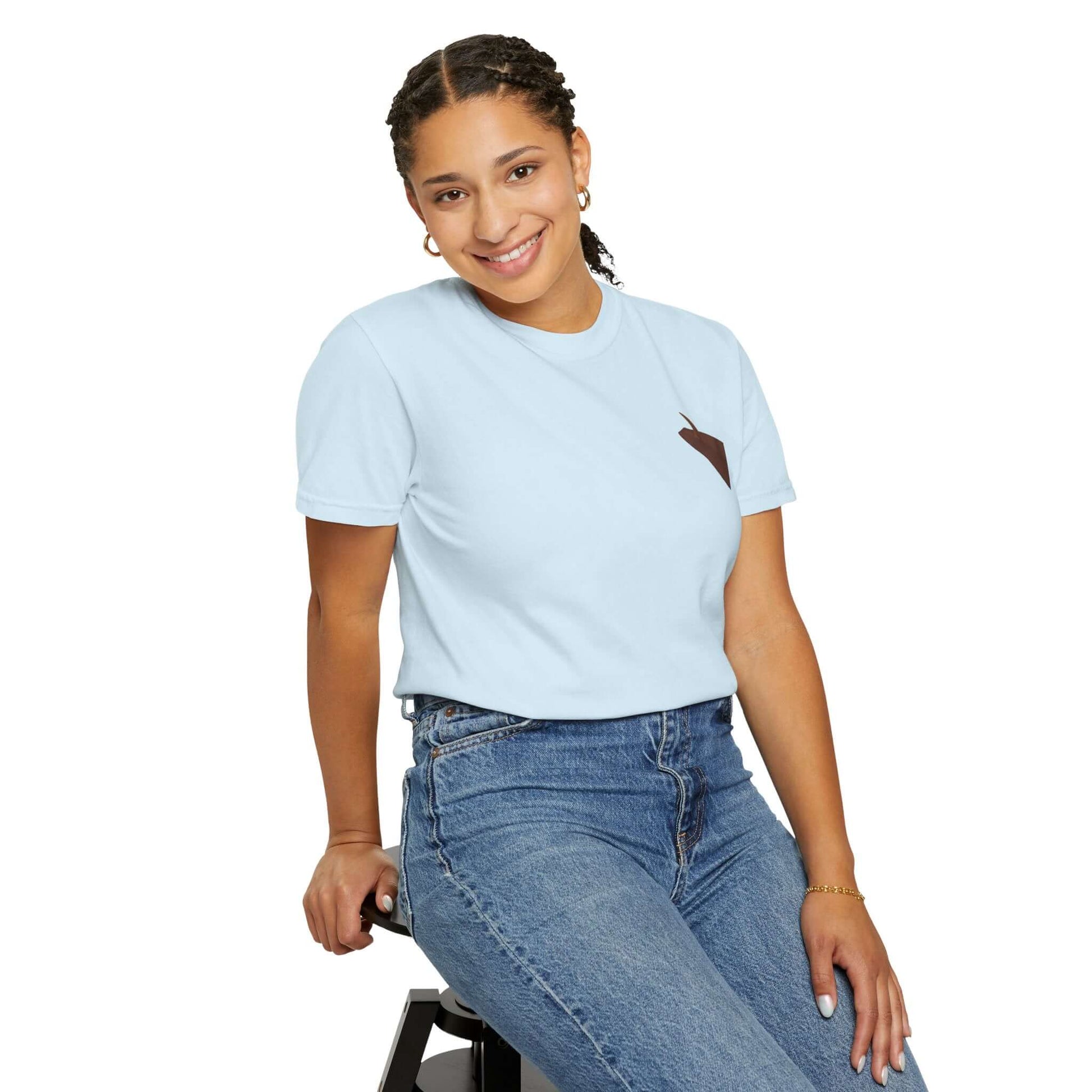 Smiling woman wearing a personalized light blue t-shirt with a unique design, showcasing summer vibes and comfort.