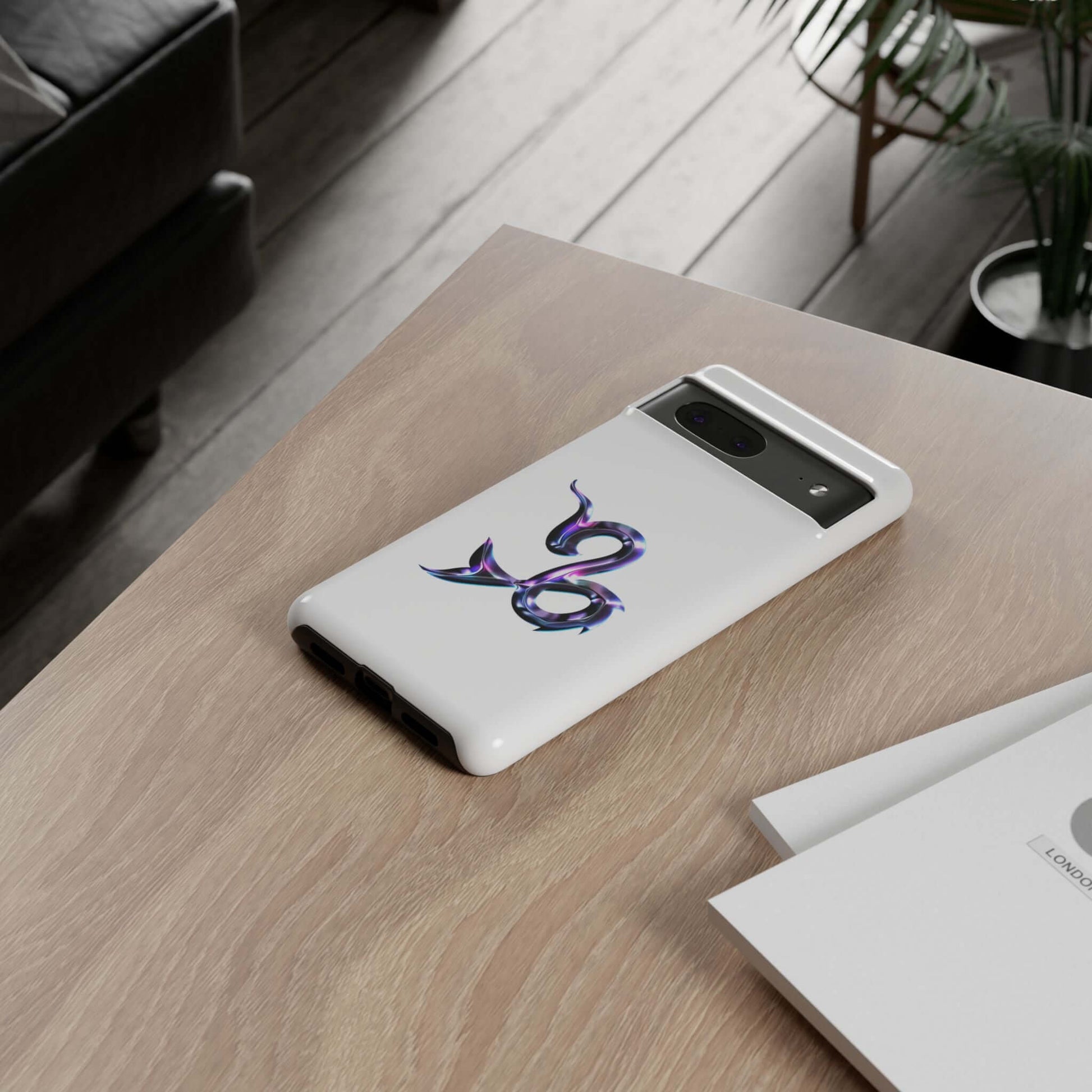 Personalized Zodiac phone case with vibrant design showcasing the astrological sign, placed on a wooden table.