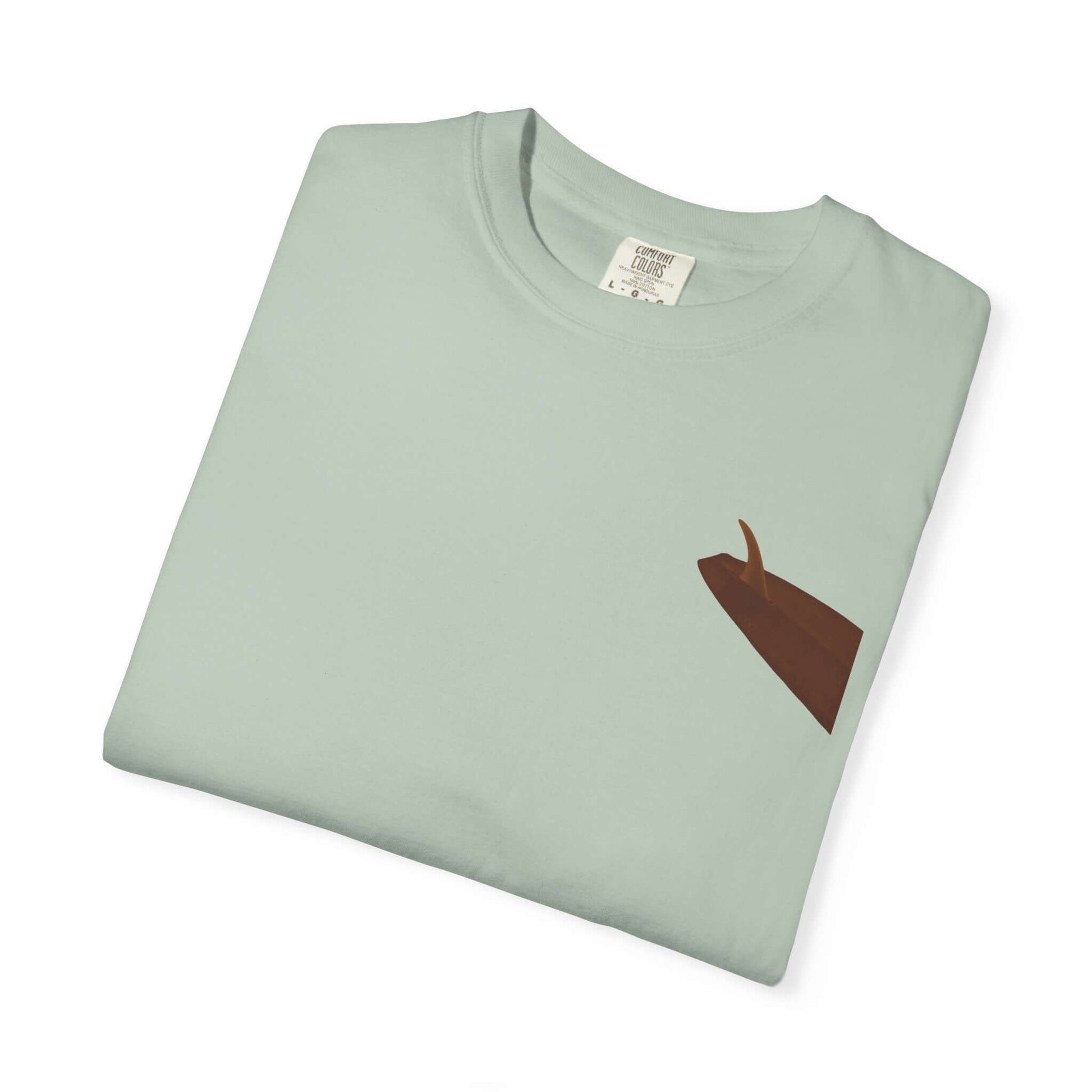 Personalized mint green surf-inspired t-shirt folded, featuring a unique brown design.
