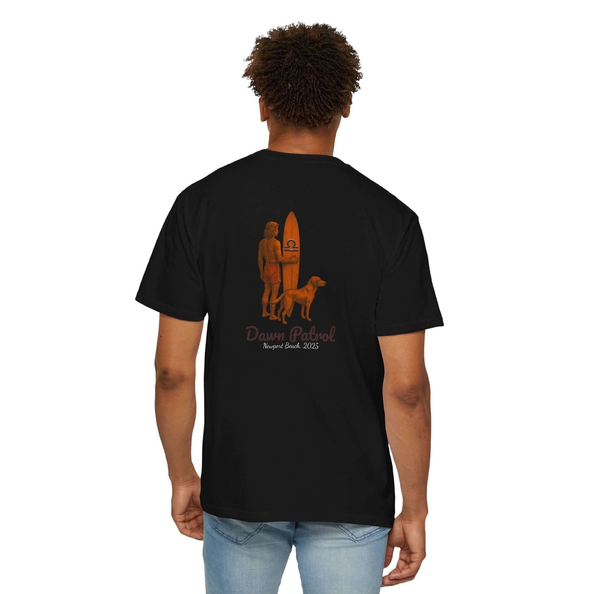 Back view of black t-shirt featuring surfer and dog design with 'Dawn Patrol' text for beach lovers.