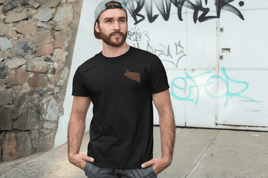 Man wearing a black personalized surf-inspired t-shirt with a cap in an urban setting.
