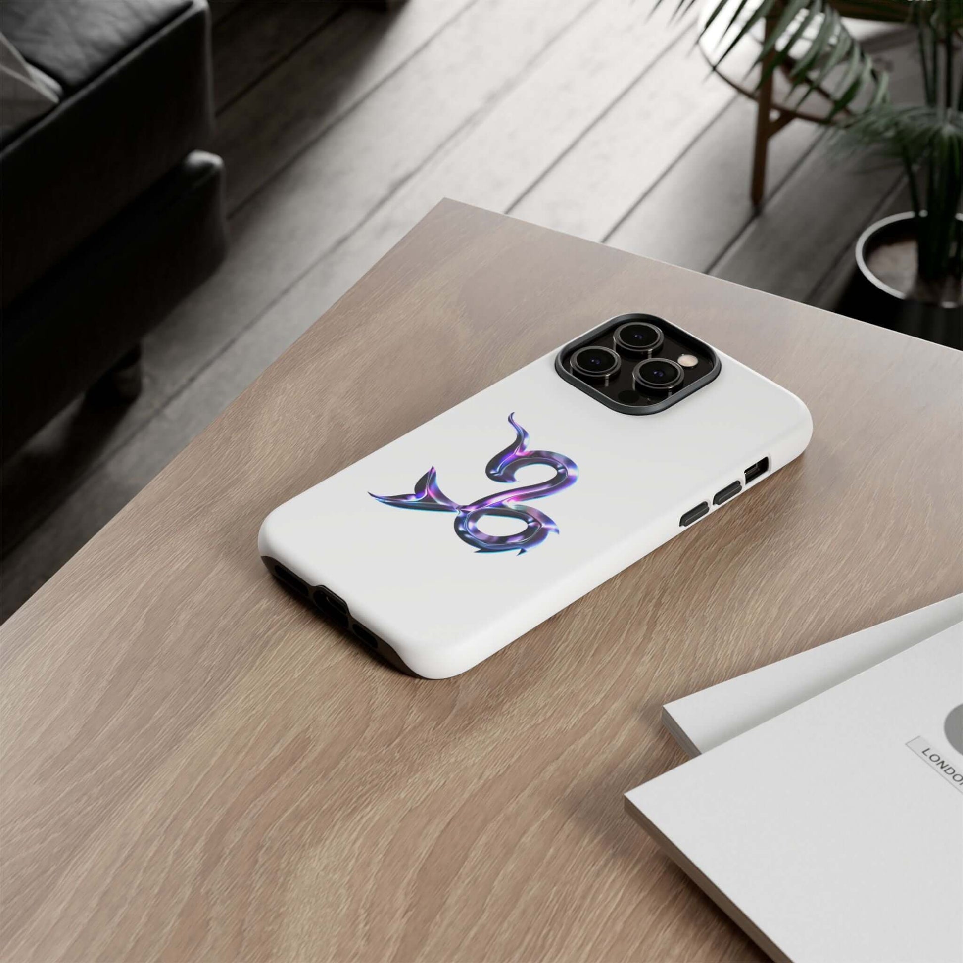 Personalized Zodiac phone case with vibrant design, resting on a wooden table, perfect for astrology lovers.