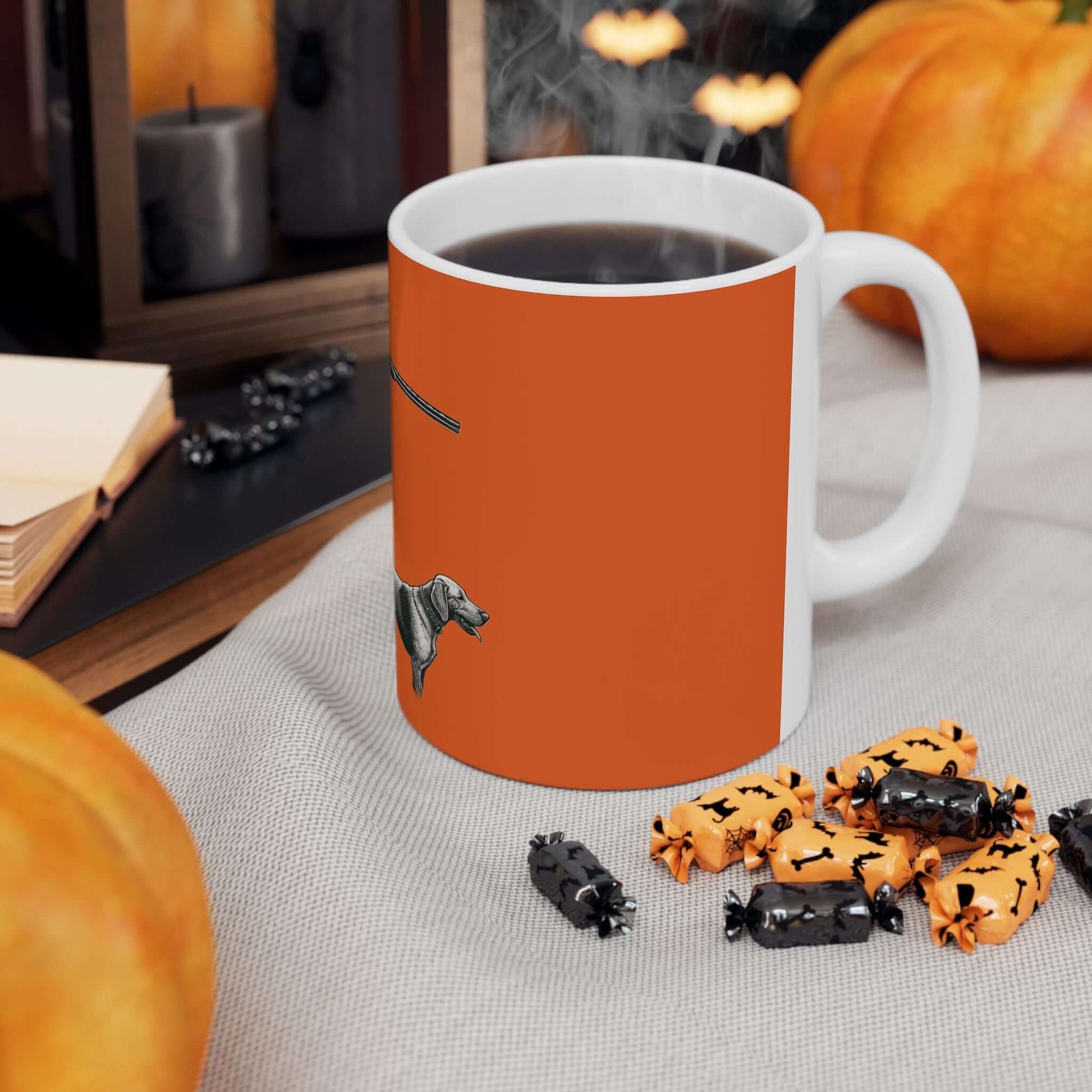 Personalized orange hunting mug with a dog design, set among pumpkins and spooky treats.