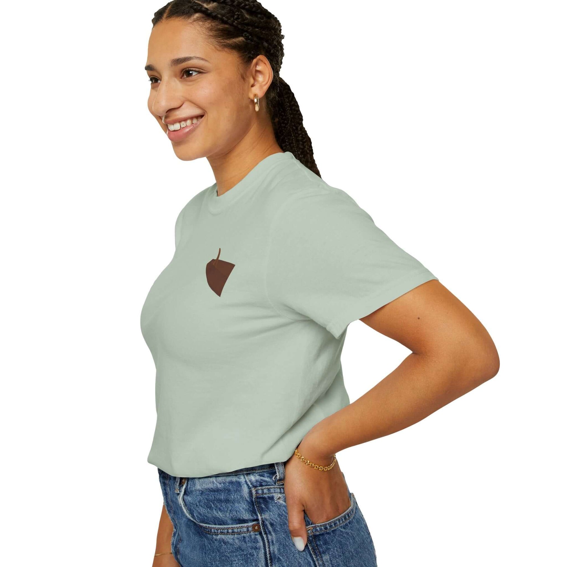 Smiling woman wearing a mint green personalized t-shirt with an acorn graphic on the chest.