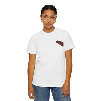 Woman modeling a personalized white t-shirt with a brown pocket design, showcasing casual summer style.