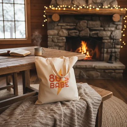 Custom Double-Sided Cotton Canvas Tote – Upload Two Designs with 80's Babe design in cozy cabin setting.