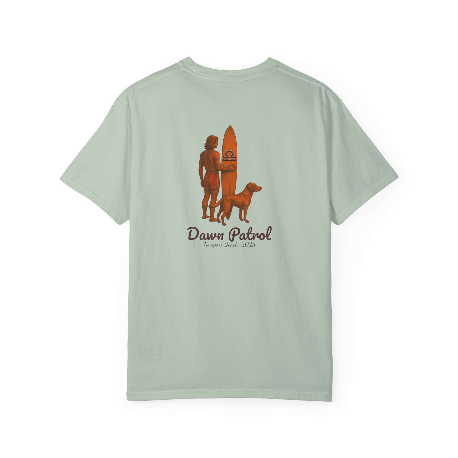 Light green t-shirt featuring a person with a surfboard and a dog, labeled 'Dawn Patrol'.