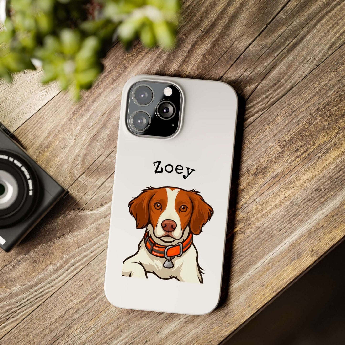 Personalized cartoon dog phone case featuring a dog named Zoey on a wooden table.