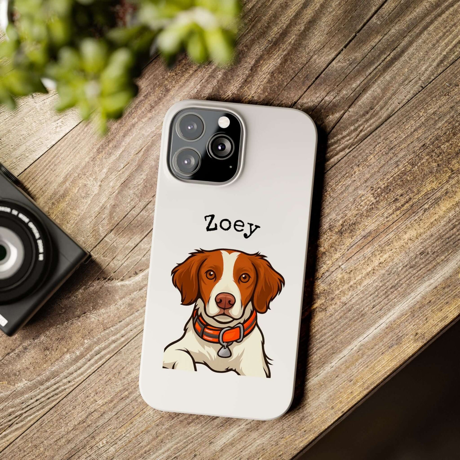 Personalized cartoon dog phone case featuring a dog named Zoey on a wooden table.