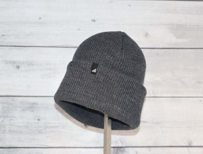 Adult Acrylic Cuff Hat – Soft Knit Beanie in gray color against a wooden background, ideal for warmth and comfort.