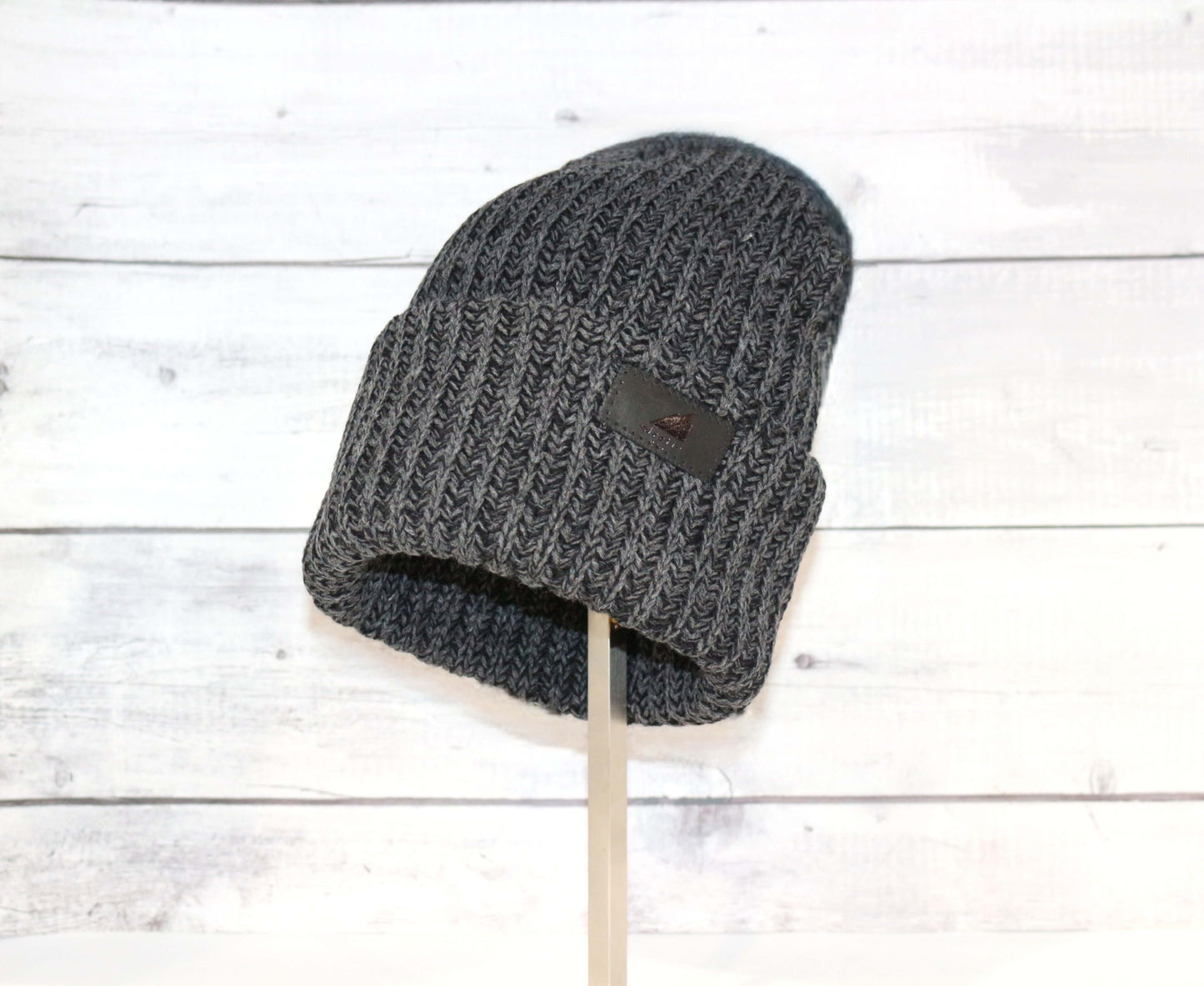 Adult Acrylic Ribbed Cuff Hat – Classic Warmth with Purpose on display against a rustic wooden background.