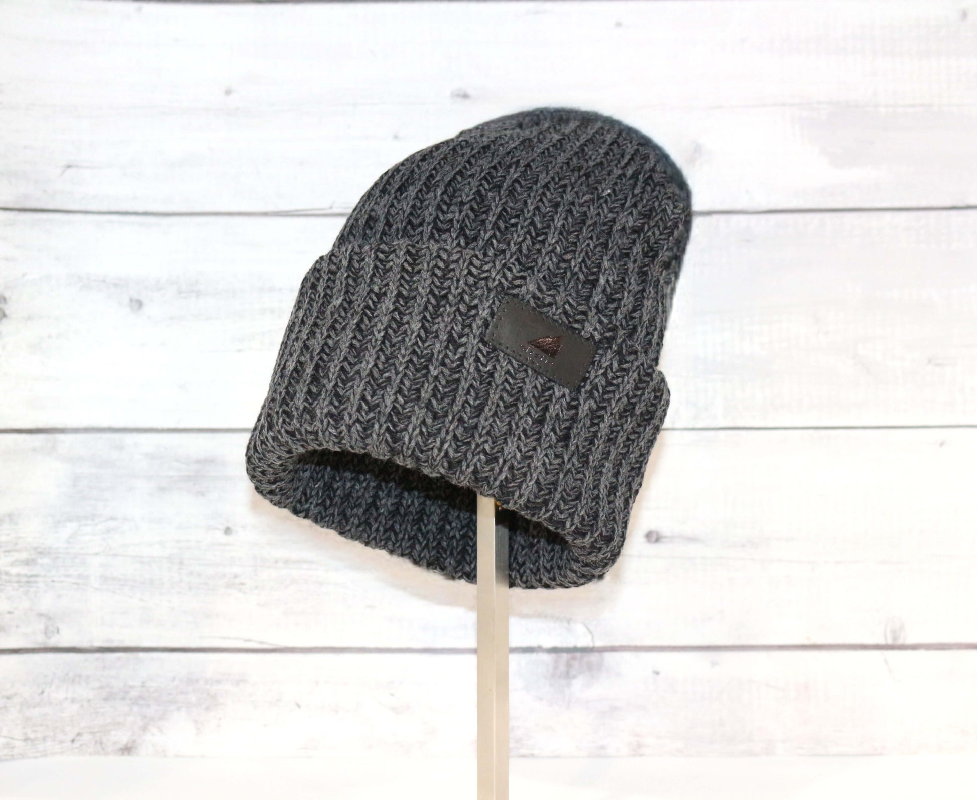 Adult Acrylic Ribbed Cuff Hat – Classic Warmth with Purpose on display against a rustic wooden background.