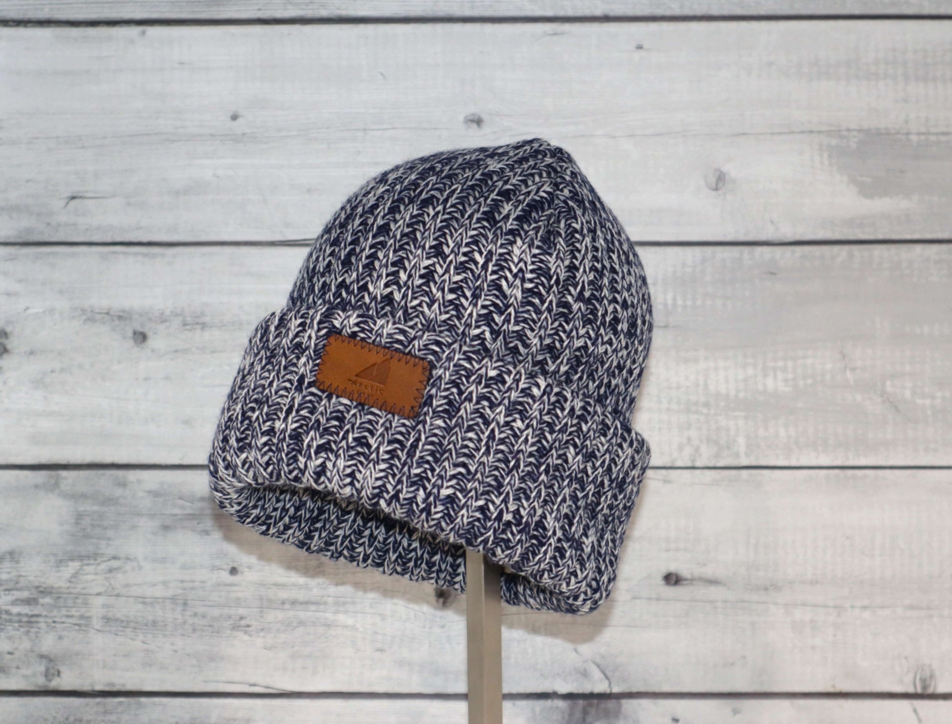 Child Acrylic Ribbed Cuff Hat – Soft, Stretchy & Purposeful displayed on a stand, featuring a cozy knitted design.