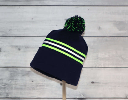 Child Specialty Hat (Ages 3–5) – Playful Warmth with Purpose featuring navy and neon stripes with a pom pom.