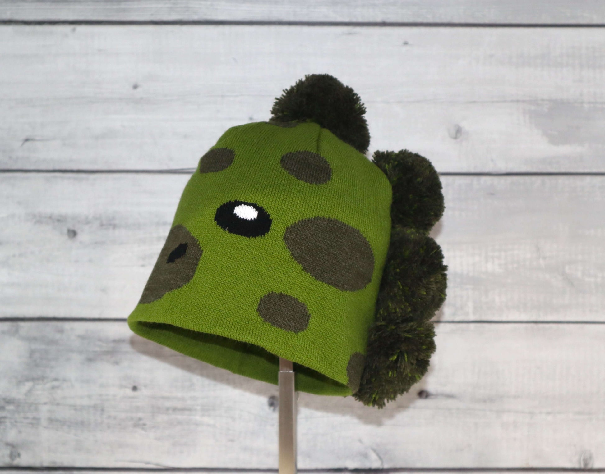 Child Specialty Hat (Ages 3–5) – Playful Warmth with Purpose in green with playful design and pom-poms.
